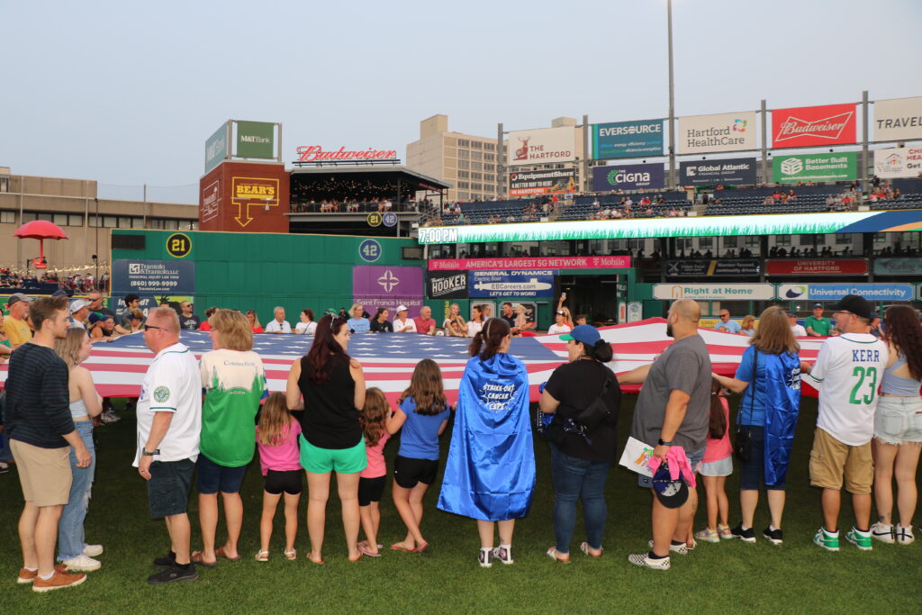 Jefferson Radiology employees on the field for the Hartford Yard Goats flag ceremony.