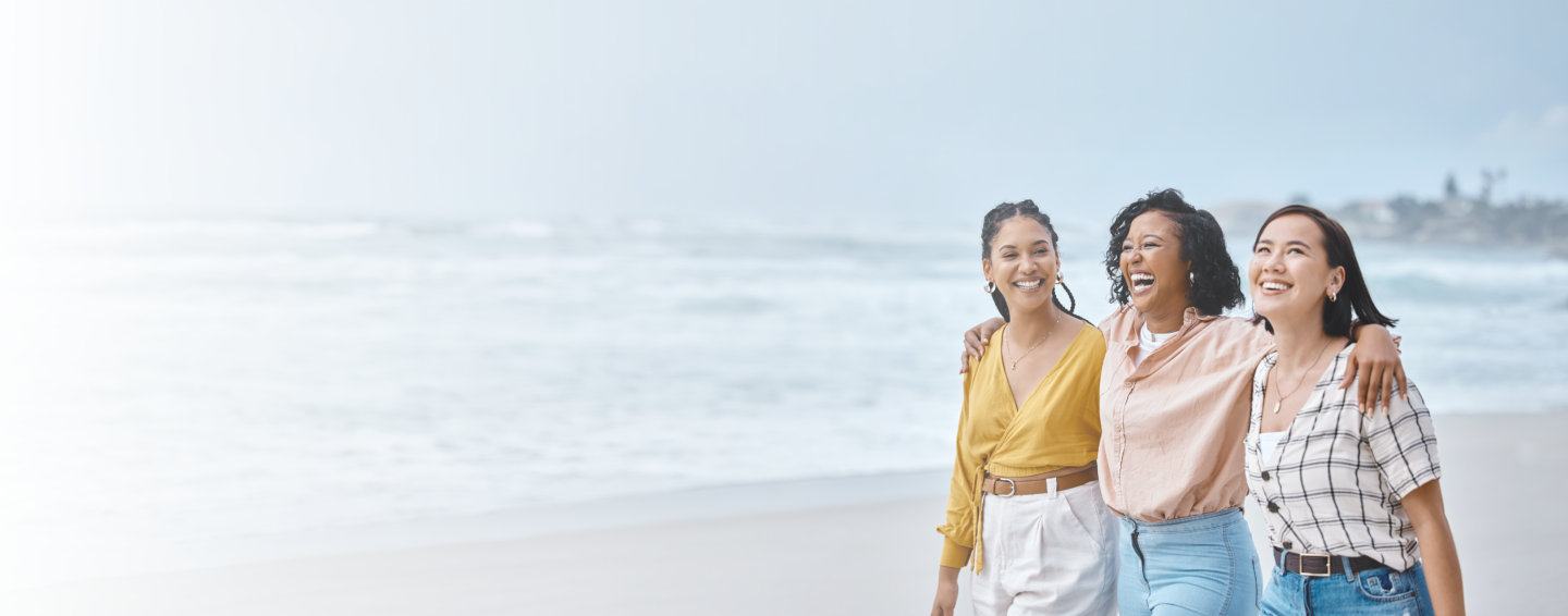 three friends walking at the beach