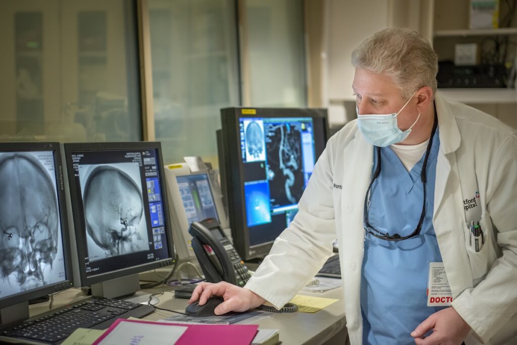 physician reviewing radiology film