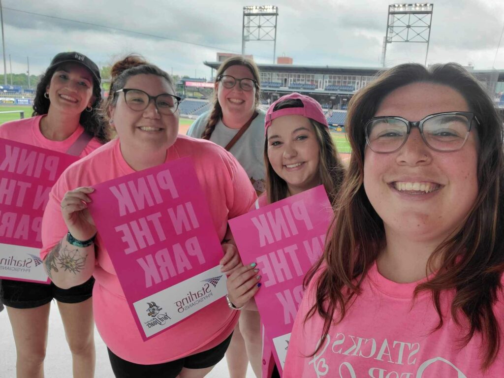 Jessica Bartolini (second from right) 32 year-old breast cancer survivor volunteering at an American Cancer Society breast cancer event.