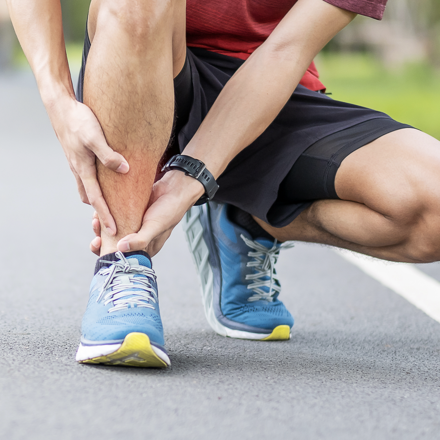 runner holding ankle after injury
