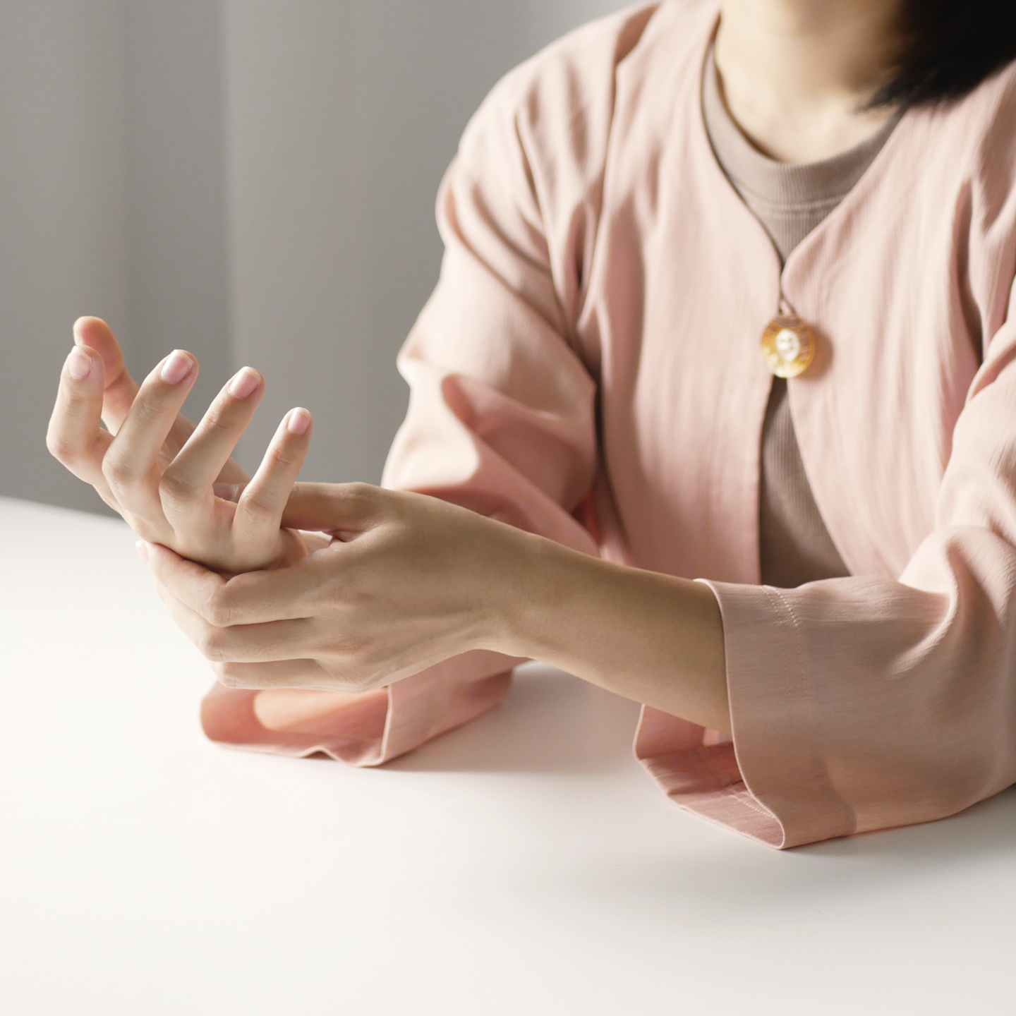 woman massaging wrist in pain