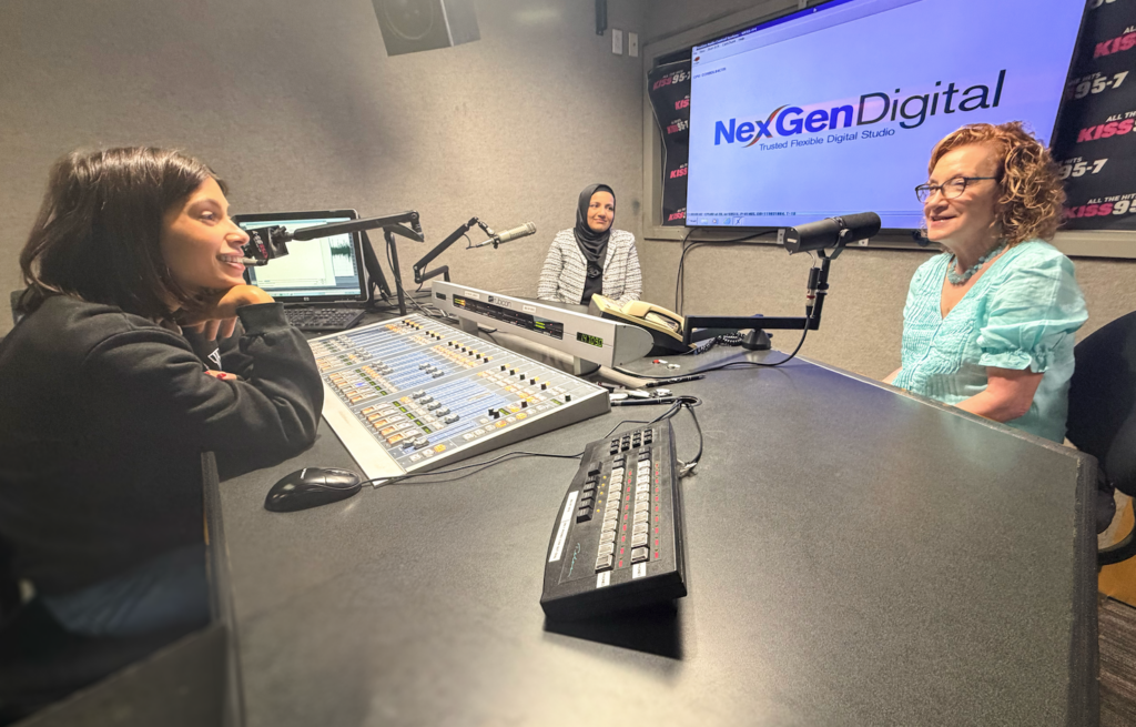 Two women in a radio studio during an interview at NexGen Digital.