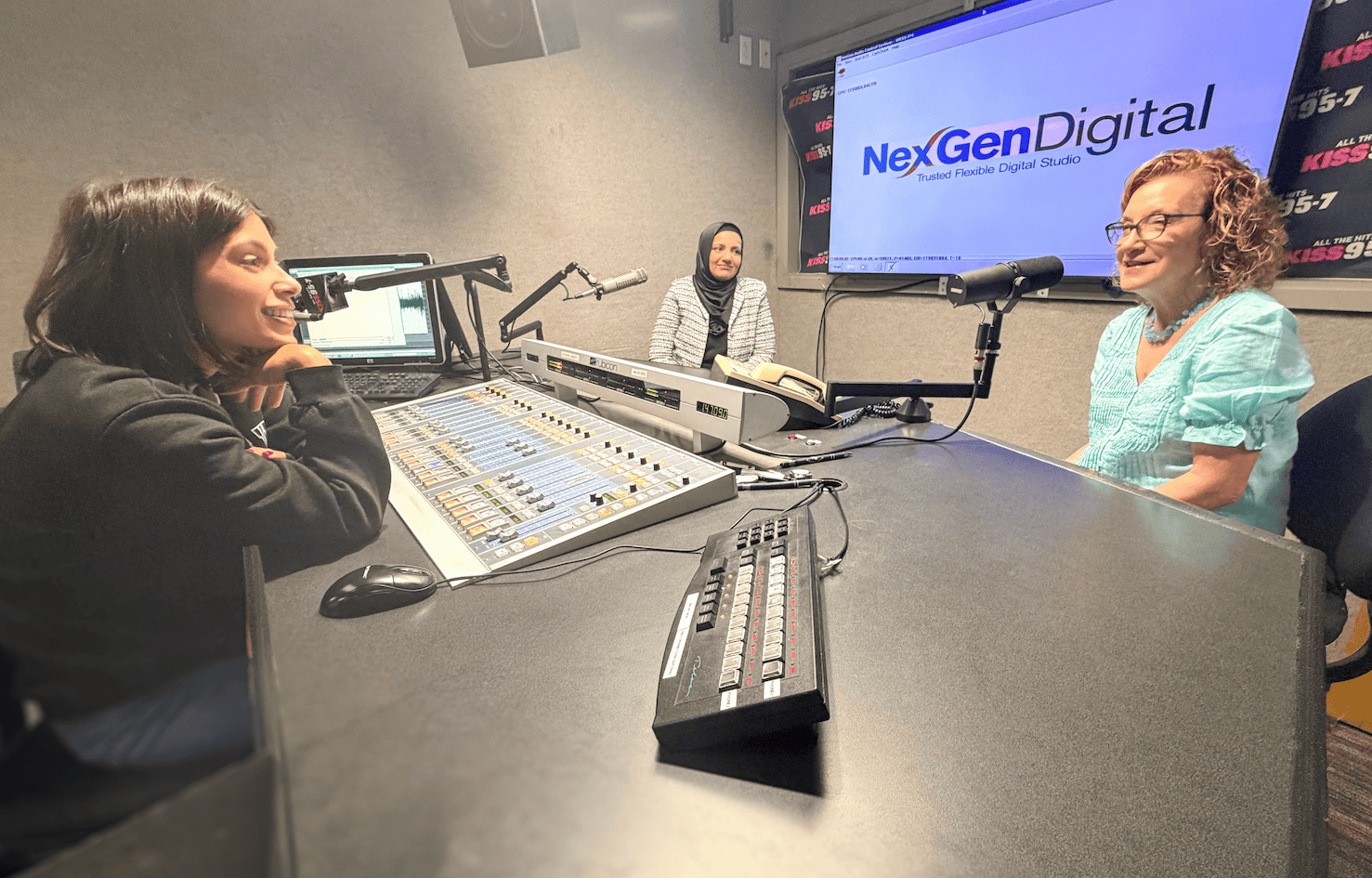 Two women in a radio studio during an interview at NexGen Digital.